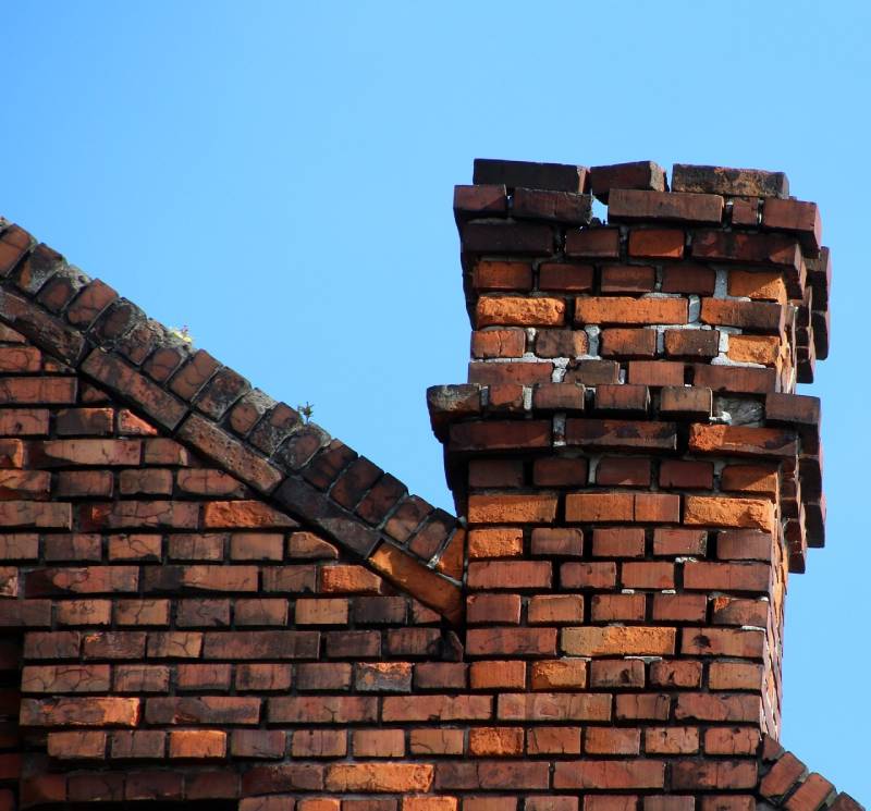 Damaged chimney on an Oak Park home showing cracks and missing mortar